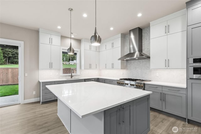 14449 133rd Pl NE, Woodinville, WA 98072 - kitchen with wall chimney exhaust hood, gray cabinets, a center island, and recessed lighting