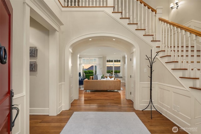 2665 Evergreen Point Rd NE, Medina, WA 98039 - entrance foyer with arched walkways, wood finished floors, and stairs