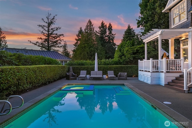 2665 Evergreen Point Rd NE, Medina, WA 98039 - pool at dusk with a patio area, a pergola, and a pool with connected hot tub