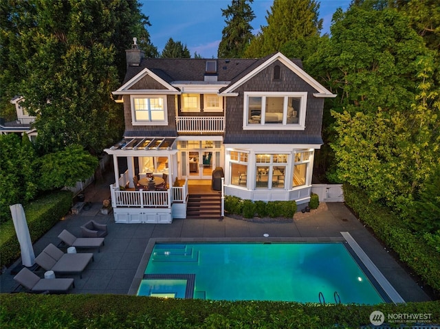 2665 Evergreen Point Rd NE, Medina, WA 98039 - rear view of house featuring a balcony, a chimney, a patio, and a pool with connected hot tub