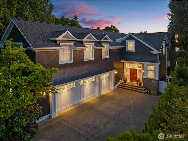 2665 Evergreen Point Rd NE, Medina, WA 98039 - view of front of house with concrete driveway, stone siding, and an attached garage