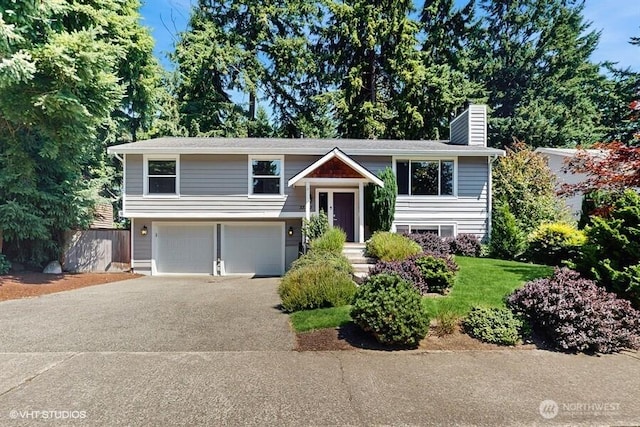 33700 33rd Pl SW, Federal Way, WA 98023 - bi-level home with an attached garage, a chimney, and concrete driveway