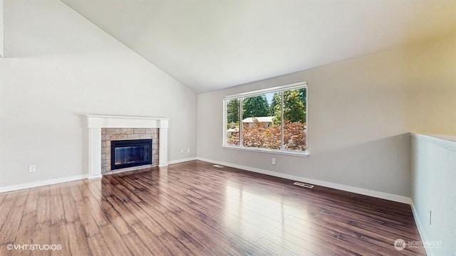 33700 33rd Pl SW, Federal Way, WA 98023 - unfurnished living room with wood finished floors, lofted ceiling, and a glass covered fireplace