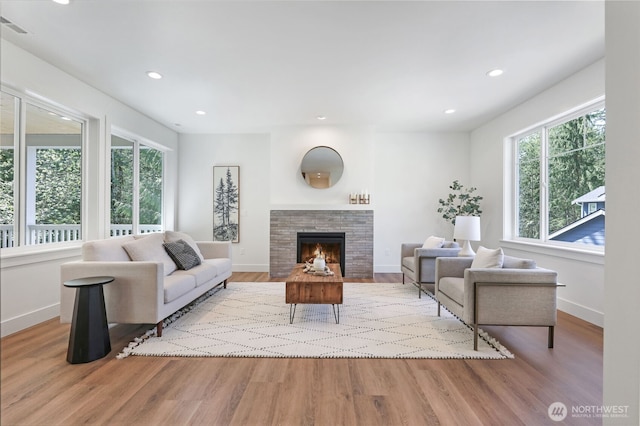 16806 62nd St SE, Snohomish, WA 98290 - living room featuring wood finished floors, a tiled fireplace, and recessed lighting