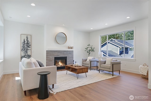 16806 62nd St SE, Snohomish, WA 98290 - living room featuring wood finished floors, a glass covered fireplace, and recessed lighting