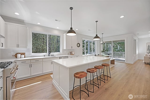 16806 62nd St SE, Snohomish, WA 98290 - kitchen featuring stainless steel appliances, tasteful backsplash, white cabinets, recessed lighting, and a kitchen island