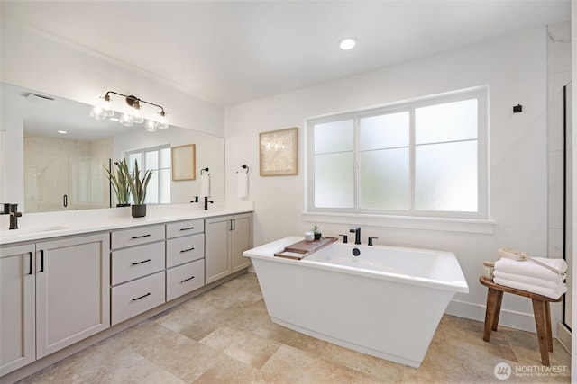 16806 62nd St SE, Snohomish, WA 98290 - bathroom with double vanity, a freestanding bath, and a stall shower