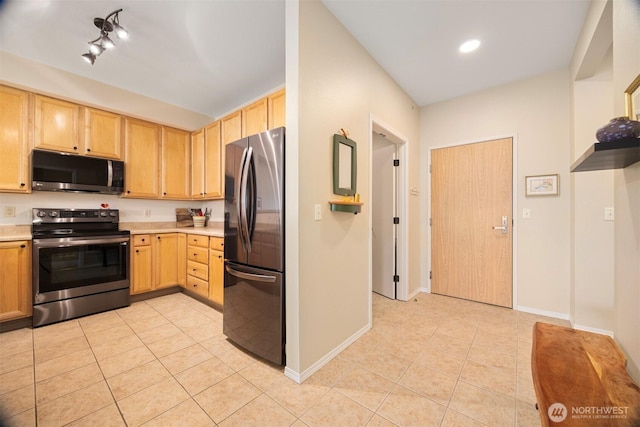 516 Darby Dr Unit 207, Bellingham, WA 98226 - kitchen featuring appliances with stainless steel finishes, light tile patterned floors, light countertops, and light brown cabinetry