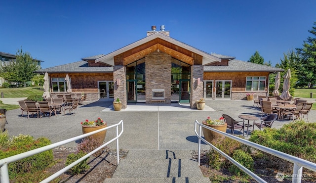 516 Darby Dr Unit 207, Bellingham, WA 98226 - rear view of property with french doors, a patio, and stone siding