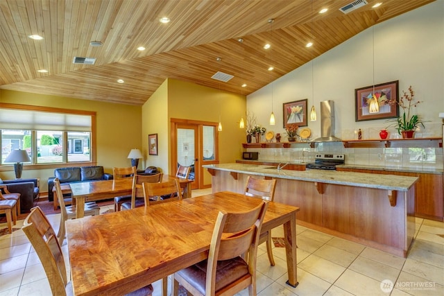 516 Darby Dr Unit 207, Bellingham, WA 98226 - dining area featuring vaulted ceiling, wood ceiling, light tile patterned floors, recessed lighting, and french doors