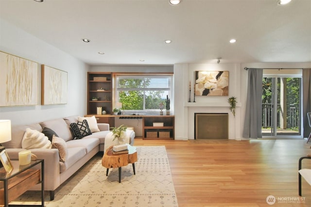 13021 SE 38th St Unit J8, Bellevue, WA 98006 - living area featuring plenty of natural light, recessed lighting, light wood-type flooring, and a fireplace