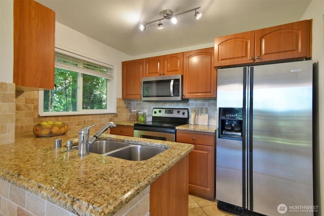 13021 SE 38th St Unit J8, Bellevue, WA 98006 - kitchen with stainless steel appliances, a peninsula, light stone counters, and tasteful backsplash