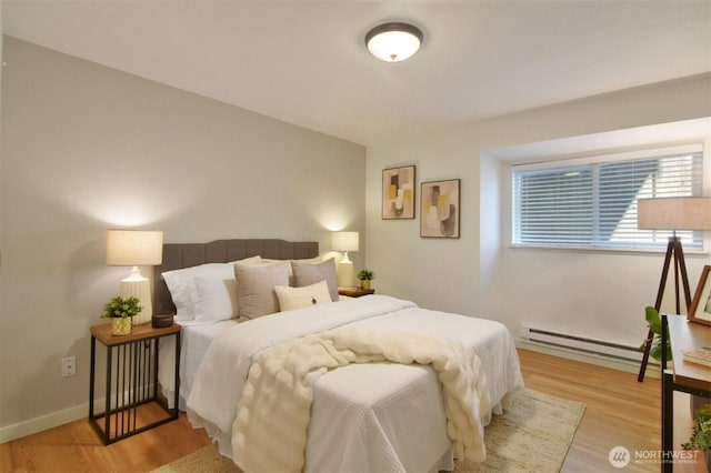 13021 SE 38th St Unit J8, Bellevue, WA 98006 - bedroom with baseboard heating and light wood-type flooring