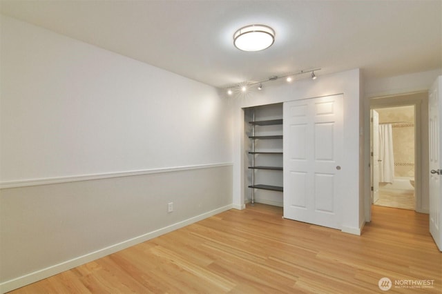 13021 SE 38th St Unit J8, Bellevue, WA 98006 - unfurnished bedroom featuring light wood-style flooring, track lighting, and a closet