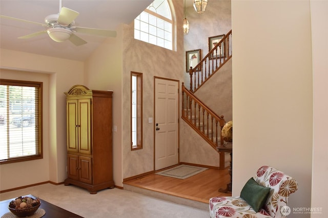 1017 Kelley Ridge Ct, Bellingham, WA 98229 - foyer entrance with stairs, a ceiling fan, carpet floors, and high vaulted ceiling