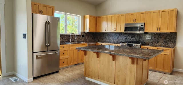 1936 Summit Lake Shore Rd NW, Olympia, WA 98502 - kitchen featuring stainless steel appliances, a breakfast bar, tasteful backsplash, a kitchen island, and light tile patterned floors