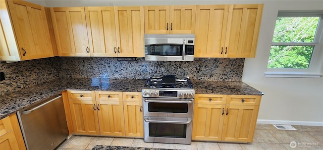 1936 Summit Lake Shore Rd NW, Olympia, WA 98502 - kitchen featuring appliances with stainless steel finishes, tasteful backsplash, dark stone counters, and light brown cabinets