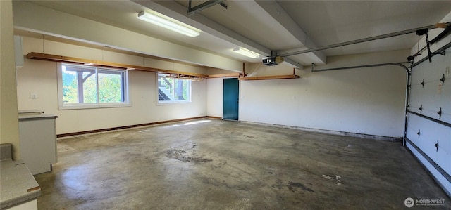 1936 Summit Lake Shore Rd NW, Olympia, WA 98502 - garage featuring baseboards and a garage door opener