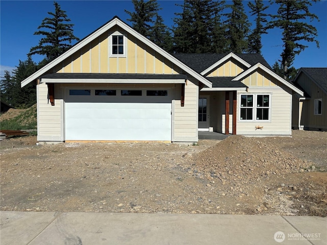 1014 Night Hawk Way, Everson, WA 98247 - view of front of home featuring dirt driveway, board and batten siding, a shingled roof, and an attached garage