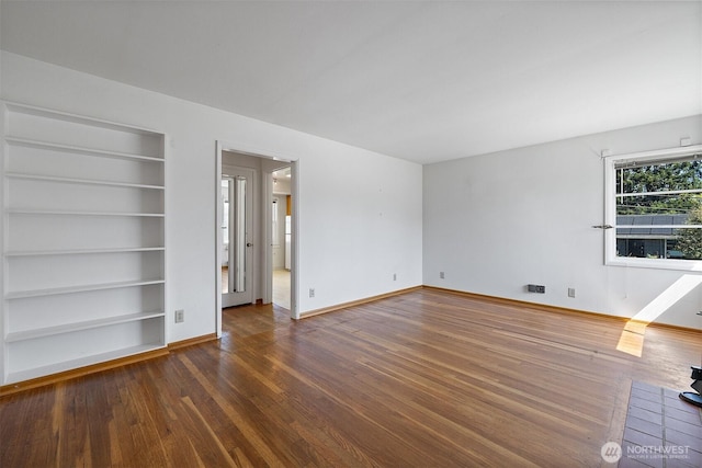 8403 36th Ave SW, Seattle, WA 98126 - spare room with wood finished floors and built in shelves