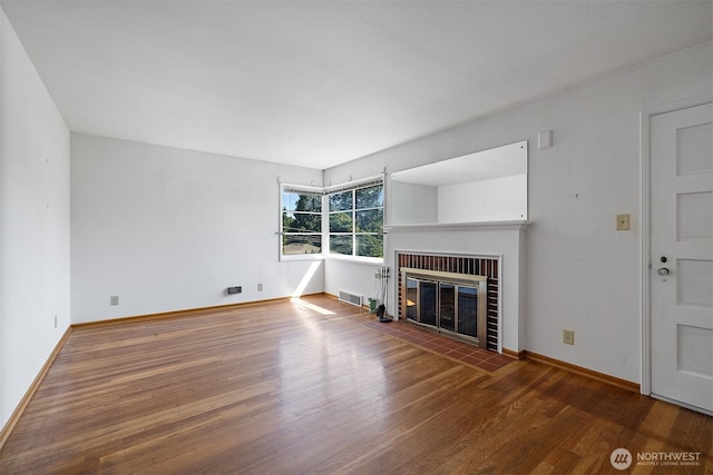 8403 36th Ave SW, Seattle, WA 98126 - unfurnished living room with wood finished floors and a brick fireplace