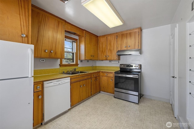 8403 36th Ave SW, Seattle, WA 98126 - kitchen featuring white appliances, under cabinet range hood, light countertops, and brown cabinets