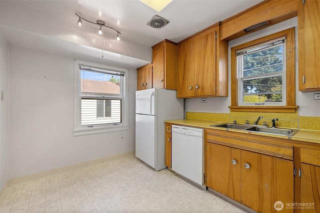 8403 36th Ave SW, Seattle, WA 98126 - kitchen featuring white appliances, brown cabinetry, light countertops, and healthy amount of natural light