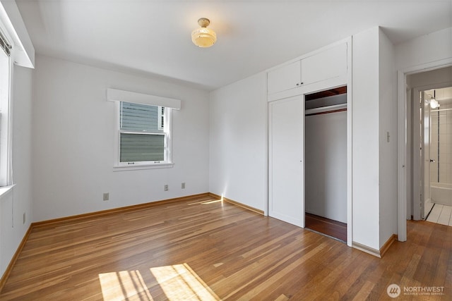 8403 36th Ave SW, Seattle, WA 98126 - unfurnished bedroom featuring light wood-style floors and a closet