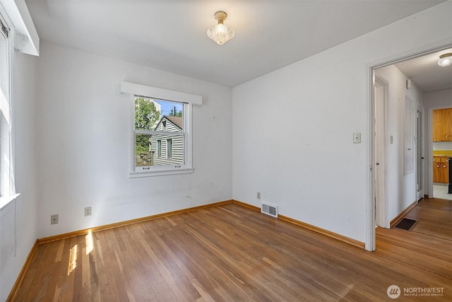 8403 36th Ave SW, Seattle, WA 98126 - unfurnished room with wood finished floors and baseboards