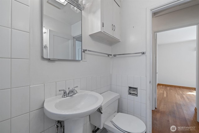 8403 36th Ave SW, Seattle, WA 98126 - bathroom featuring wood finished floors, tile walls, and tasteful backsplash