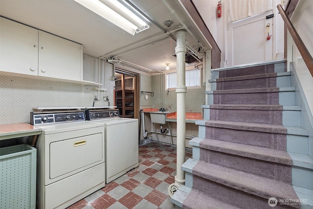 8403 36th Ave SW, Seattle, WA 98126 - laundry room featuring tile patterned floors, separate washer and dryer, and cabinet space