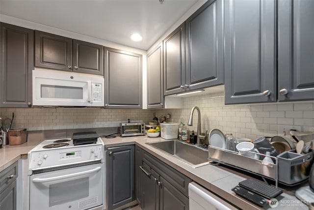 321 10th Ave S Unit 618, Seattle, WA 98104 - kitchen with white appliances, backsplash, light countertops, and gray cabinetry