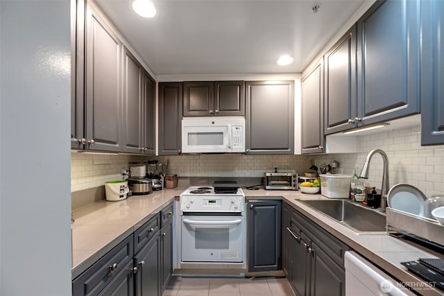 321 10th Ave S Unit 618, Seattle, WA 98104 - kitchen with white appliances, tasteful backsplash, and light countertops