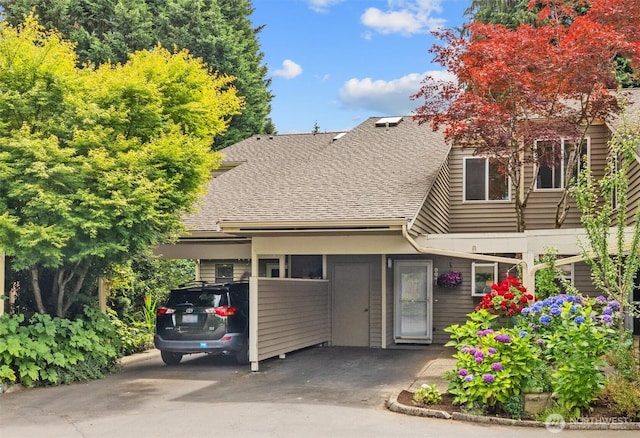 9641 NE 121st Ln, Kirkland, WA 98034 - view of front of house with a shingled roof, an attached carport, and driveway