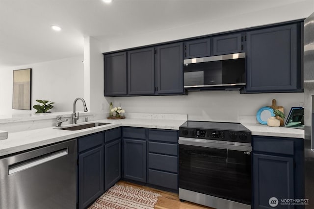 9641 NE 121st Ln, Kirkland, WA 98034 - kitchen featuring stainless steel appliances, light wood finished floors, light stone counters, and recessed lighting