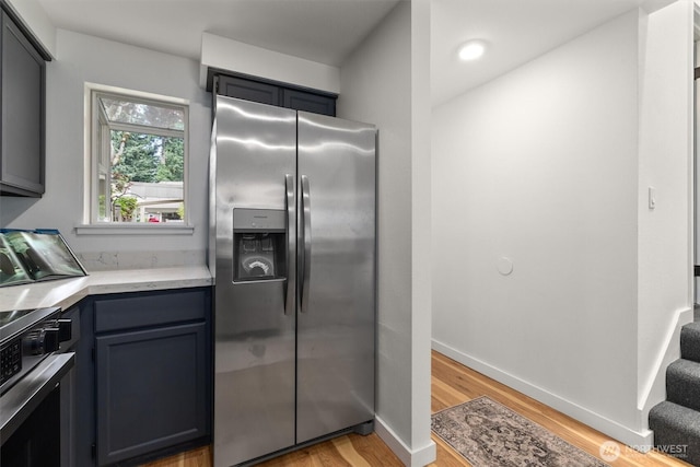 9641 NE 121st Ln, Kirkland, WA 98034 - kitchen with stainless steel fridge with ice dispenser, stove, light wood-type flooring, and gray cabinets