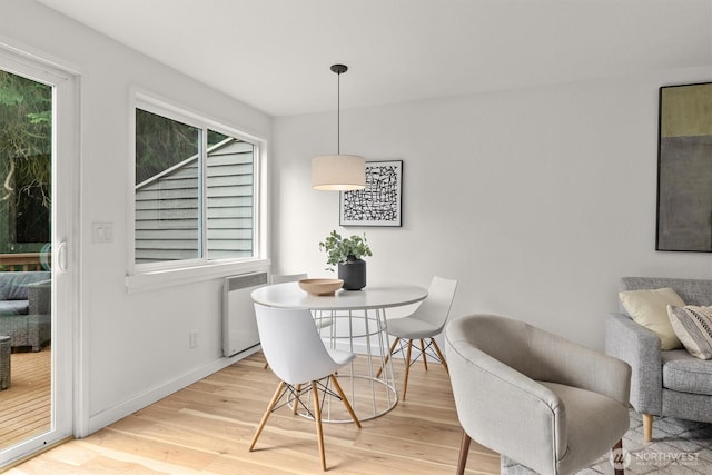 9641 NE 121st Ln, Kirkland, WA 98034 - dining space with wood finished floors, radiator heating unit, and healthy amount of natural light
