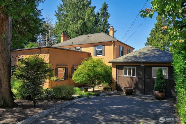 19453 Military Rd S, Seatac, WA 98188 - view of front of home featuring a chimney, stucco siding, and a shingled roof