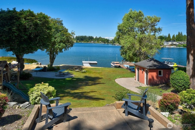 19453 Military Rd S, Seatac, WA 98188 - view of green lawn featuring a water view, a patio, a boat dock, and an outdoor structure