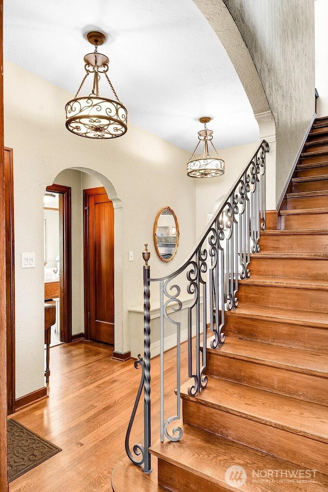 19453 Military Rd S, Seatac, WA 98188 - stairs featuring wood finished floors and arched walkways