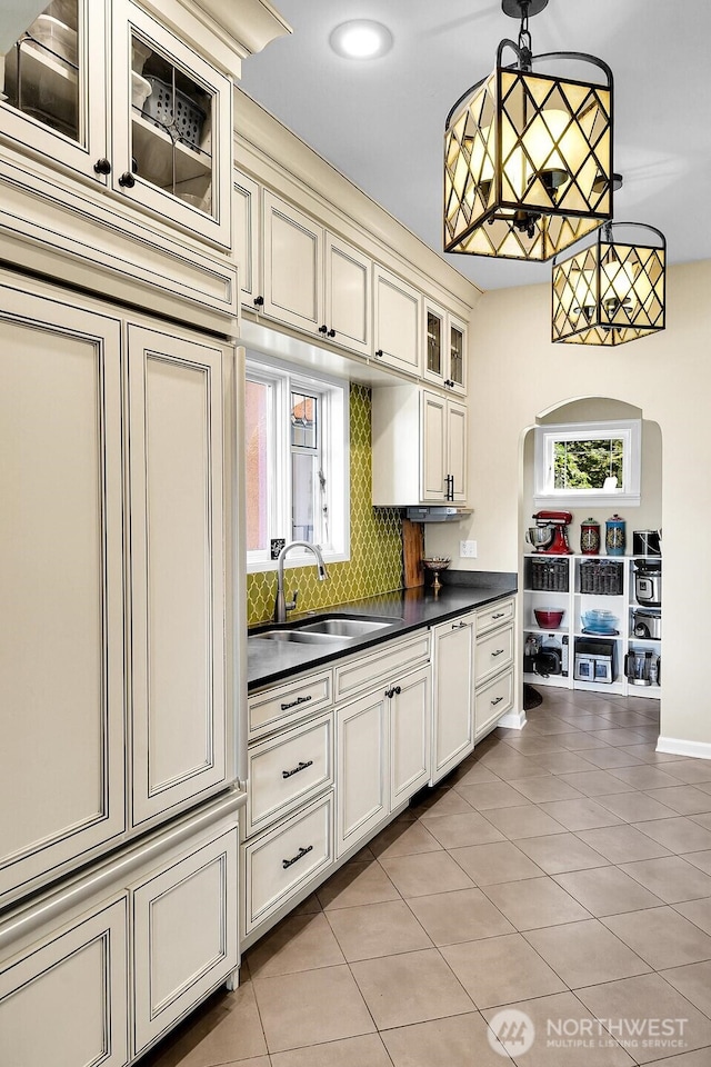 19453 Military Rd S, Seatac, WA 98188 - kitchen with dark countertops, tasteful backsplash, light tile patterned flooring, cream cabinetry, and recessed lighting
