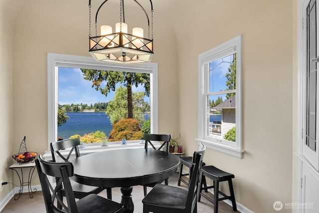 19453 Military Rd S, Seatac, WA 98188 - dining area with healthy amount of natural light, a chandelier, light tile patterned flooring, and a water view