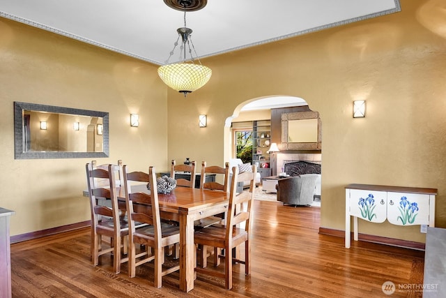 19453 Military Rd S, Seatac, WA 98188 - dining area with wood finished floors, arched walkways, and a tiled fireplace