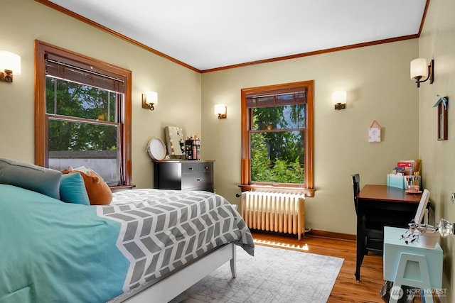 19453 Military Rd S, Seatac, WA 98188 - bedroom featuring radiator heating unit, multiple windows, wood finished floors, and ornamental molding
