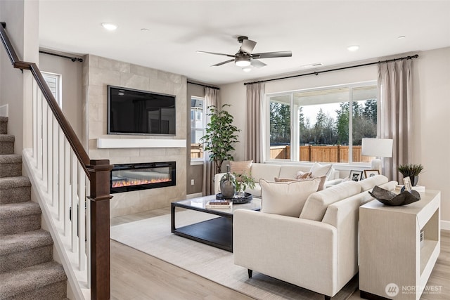 18019 139th Pl E Unit 19, Puyallup, WA 98374 - living area featuring wood finished floors, stairway, a ceiling fan, a tile fireplace, and recessed lighting
