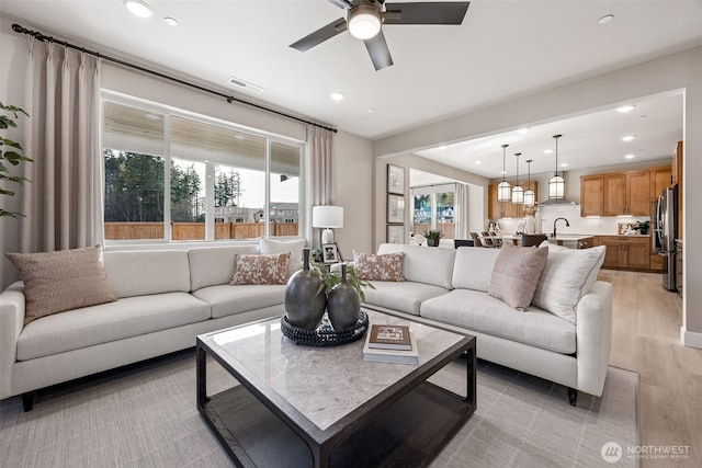 18019 139th Pl E Unit 19, Puyallup, WA 98374 - living area with light wood-type flooring, a ceiling fan, plenty of natural light, and recessed lighting