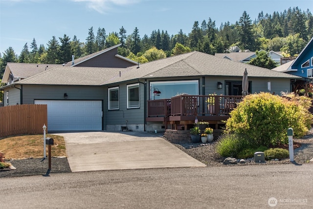 70 Onyx Ln, Sequim, WA 98382 - single story home with a garage, concrete driveway, a wooden deck, and a shingled roof