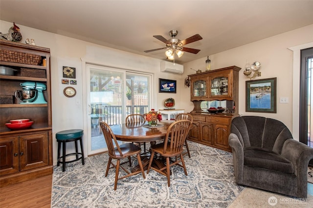 70 Onyx Ln, Sequim, WA 98382 - dining area featuring a wall mounted AC, ceiling fan, and light wood-style floors
