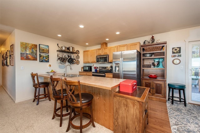70 Onyx Ln, Sequim, WA 98382 - kitchen featuring stainless steel appliances, a kitchen bar, recessed lighting, light brown cabinets, and a peninsula