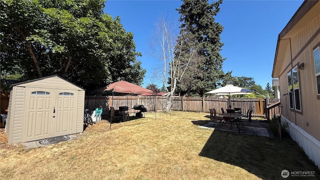 10426 11th Avenue Ct S, Tacoma, WA 98444 - fenced backyard with a storage shed and a patio area